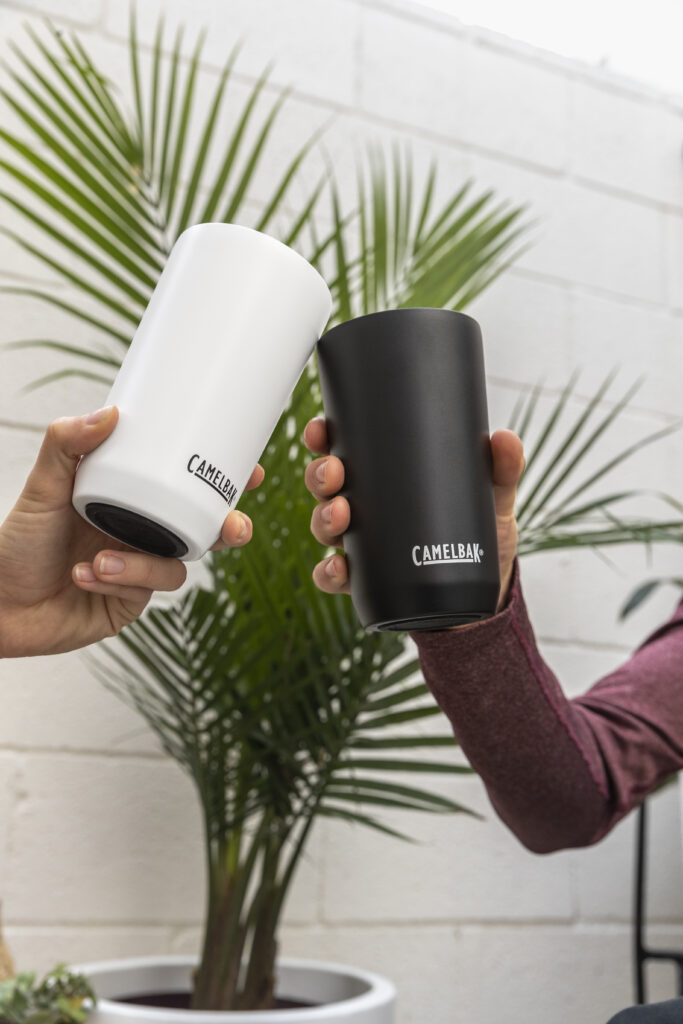 Two camelbak tumblers being held by two different people.