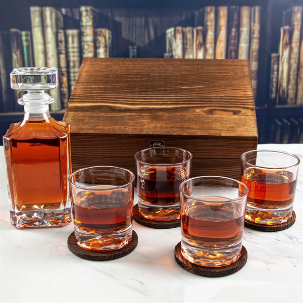 A box of a whiskey set with a decanter and four glasses.