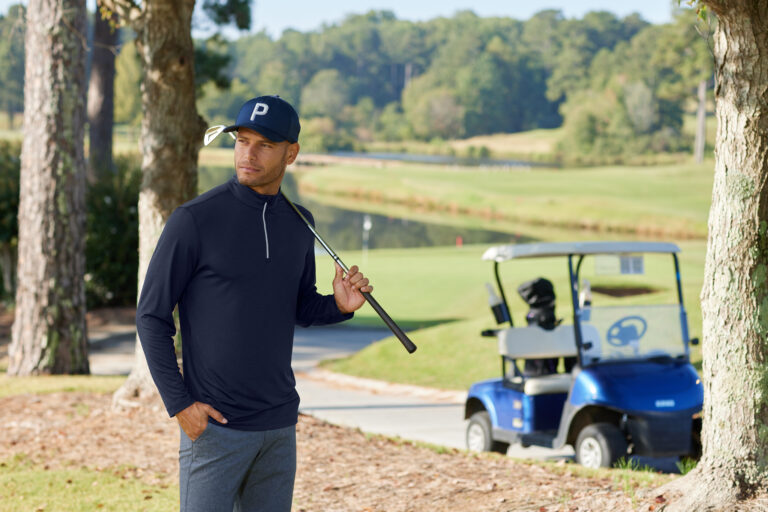 A golfer wearing branded golf apparel