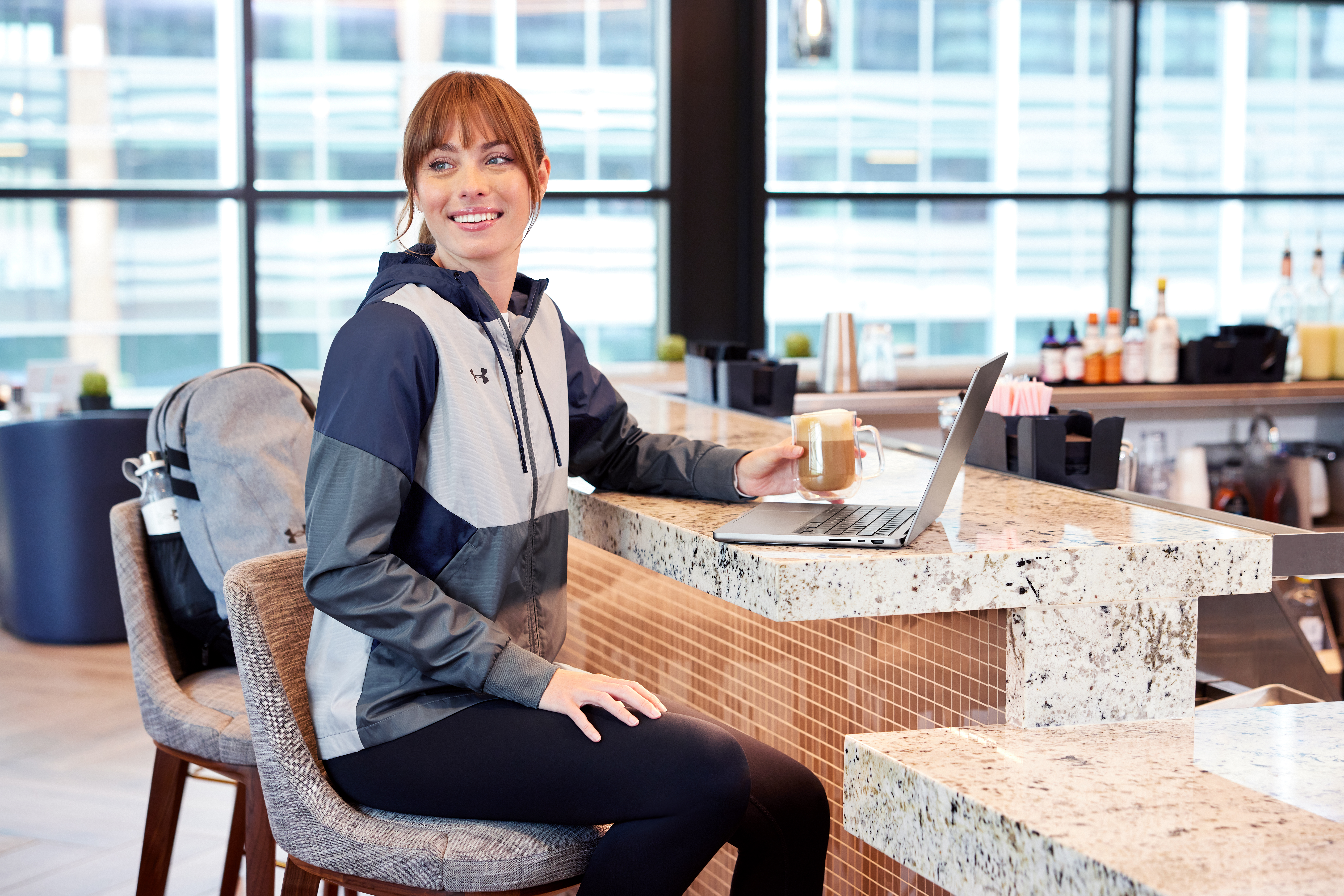 A smiling woman working in a coffeeshop