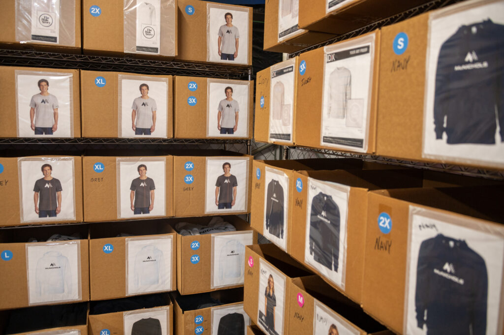 Shelves full of branded t-shirts and pullovers