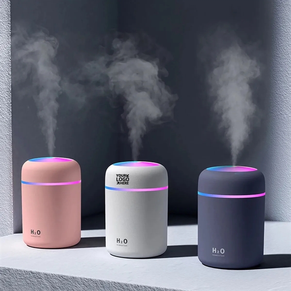 Three small H2O humidifiers in pink, gray, and black.