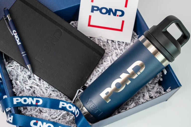 A custom box with a tumbler, notebook, and pen inside for the company Pond.