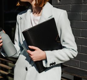 Chic woman holding a bottle.