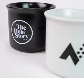 A mug with The Hole Story logo