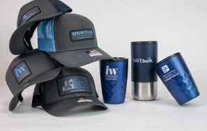 A collection of hats stacked on top of each other and three different tumblers.