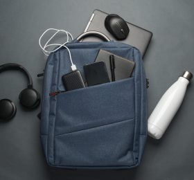 Office accessories including a backpack, water bottle, headphones, charging bank and mouse.